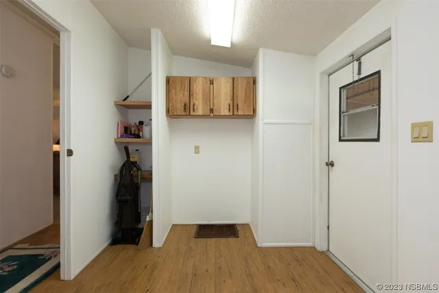 a view of a room with wooden floor and cabinet