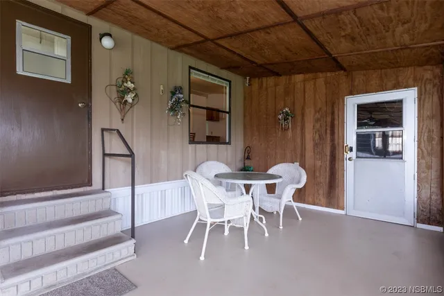 a swimming pool with outdoor seating and yard