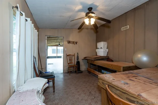 a view of a dining room with furniture and a window