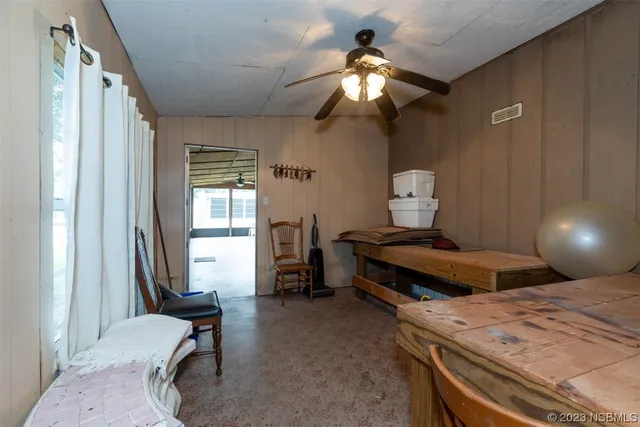 a view of a dining room with furniture and a window