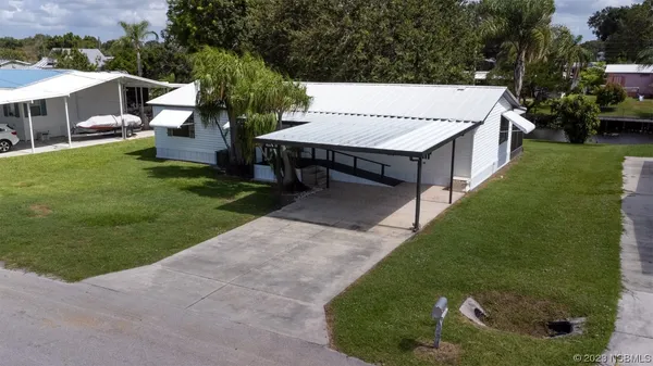 a view of a house with a yard and garage