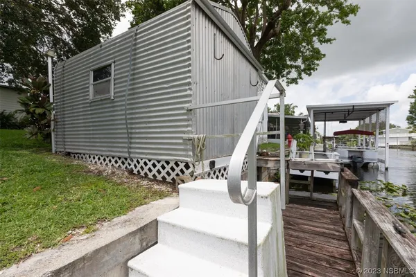 a view of backyard with a table and chairs