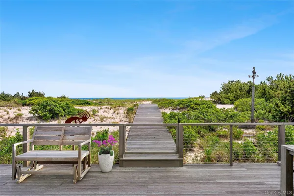 a view of a terrace with glass top table and chairs