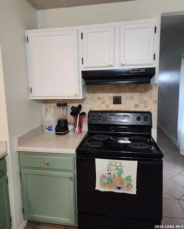 a kitchen with stainless steel appliances granite countertop a stove and a microwave