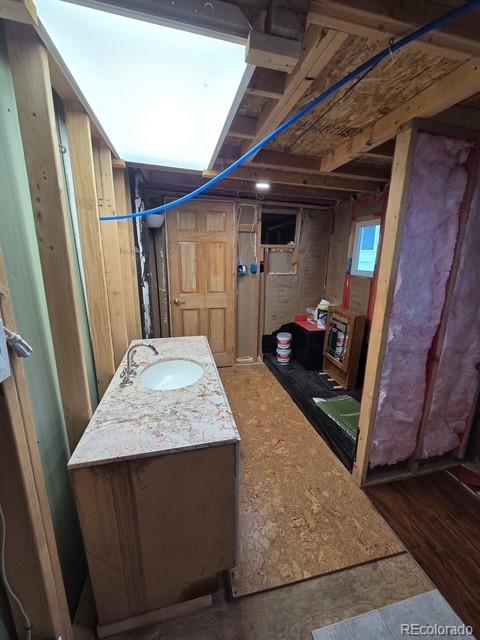 325 Aspen Road Idaho Springs, CO 80452 - Photo 2 of 10 a bedroom with a bed and wooden floor