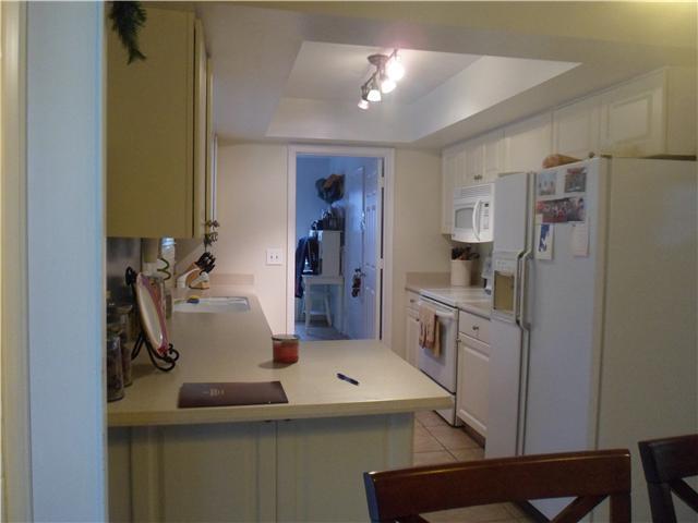 4561 Southeast Shady Ridge Lane Stuart, FL 34997 - Photo 5 of 25 a kitchen with kitchen island a sink stove and refrigerator