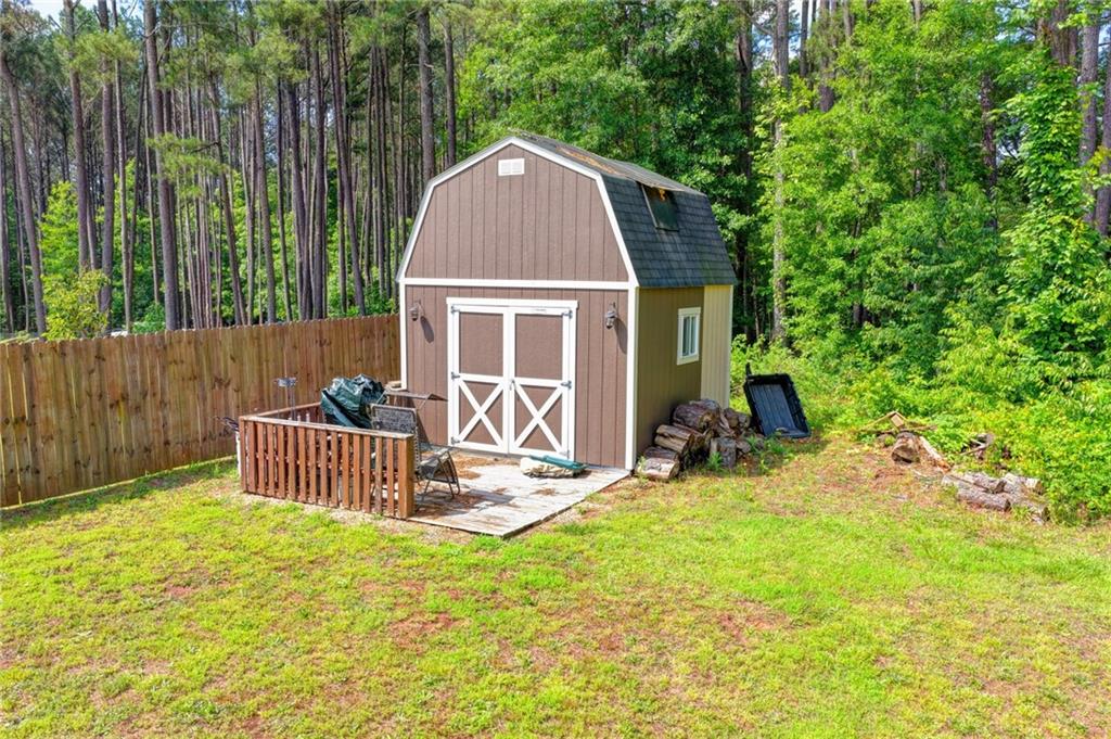204 Lynn Road Bethlehem, GA 30620 - Photo 35 of 44 a view of backyard with a garden and deck
