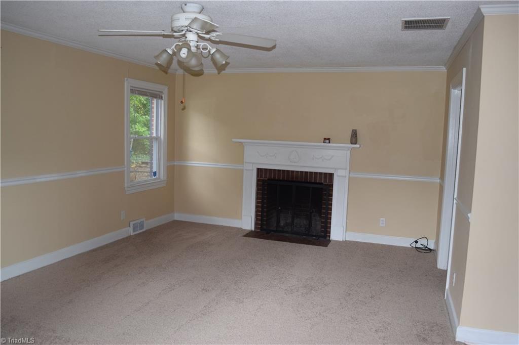 273 Milling Road Mocksville, NC 27028 - Photo 6 of 22 Living room with wood burning fireplace, kitchen to the right