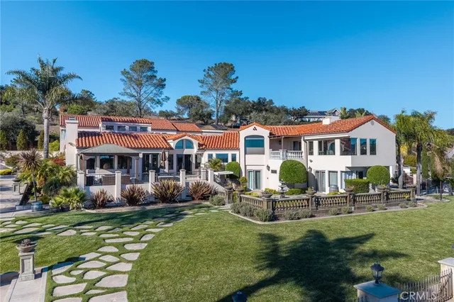 a hallway with painting on the wall and a mirror