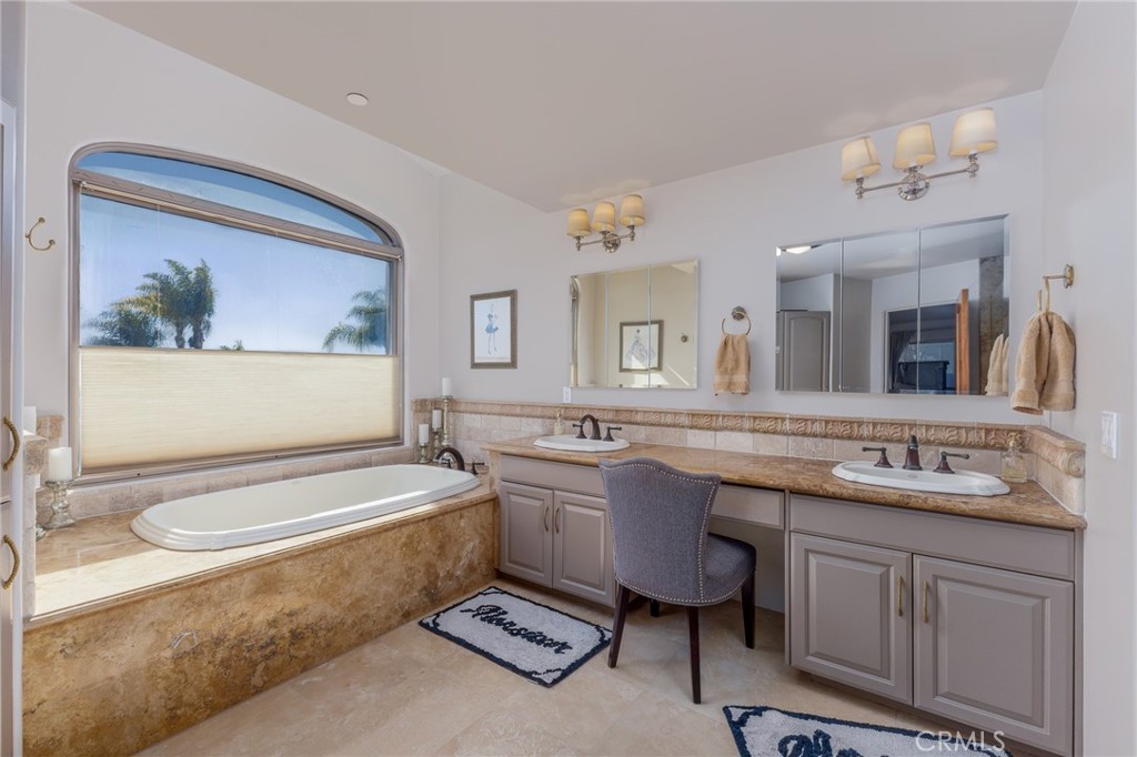 515 Windermere Lane Arroyo Grande, CA 93420 - Photo 20 of 75 a bathroom with a granite countertop sink a toilet a mirror and bathtub