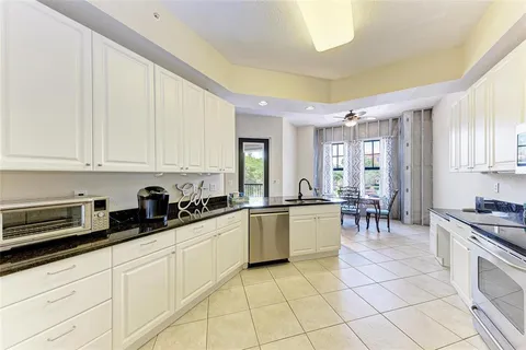 a kitchen with stainless steel appliances kitchen island granite countertop a sink and cabinets