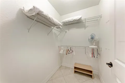 a bedroom with a bed and a view of en suite bathroom