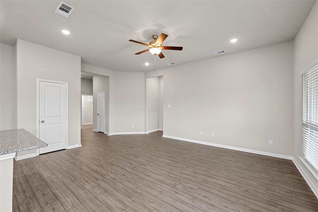3208 Dottavio Road Lorena, TX 76655 - Photo 6 of 31 Spacious interior featuring wood-finish flooring, a ceiling fan with light, recessed lighting, and a window with blinds