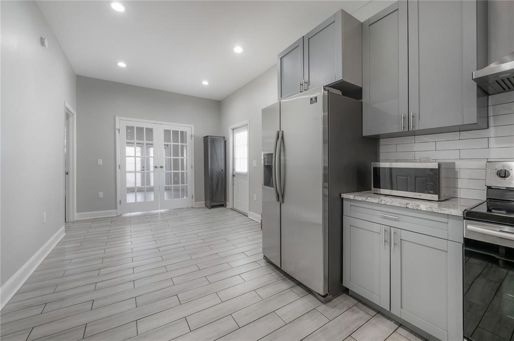 2341 West Chestnut Street Tampa, FL 33607 - Photo 12 of 42 a kitchen with stainless steel appliances a refrigerator sink and cabinets
