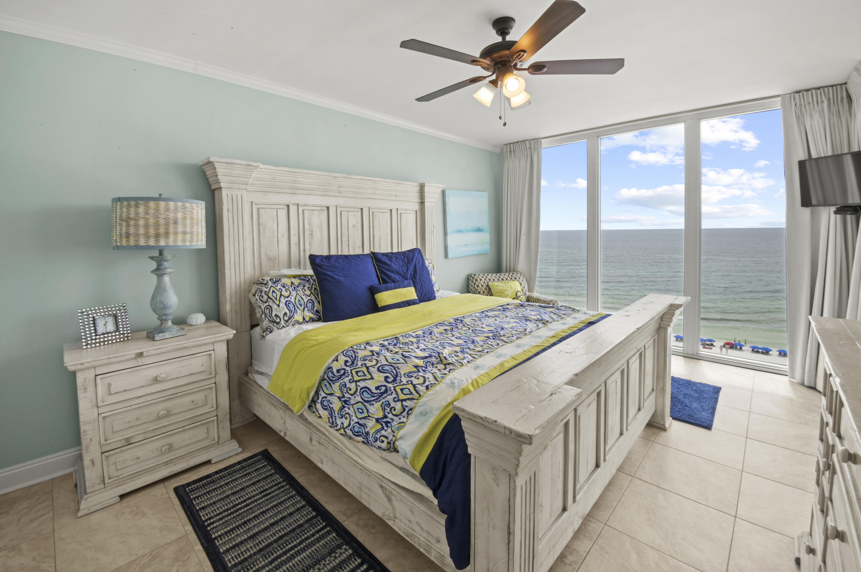 8477 Gulf Boulevard, Unit 902 Navarre, FL 32566 - Photo 12 of 36 a bedroom with a large bed and a chandelier
