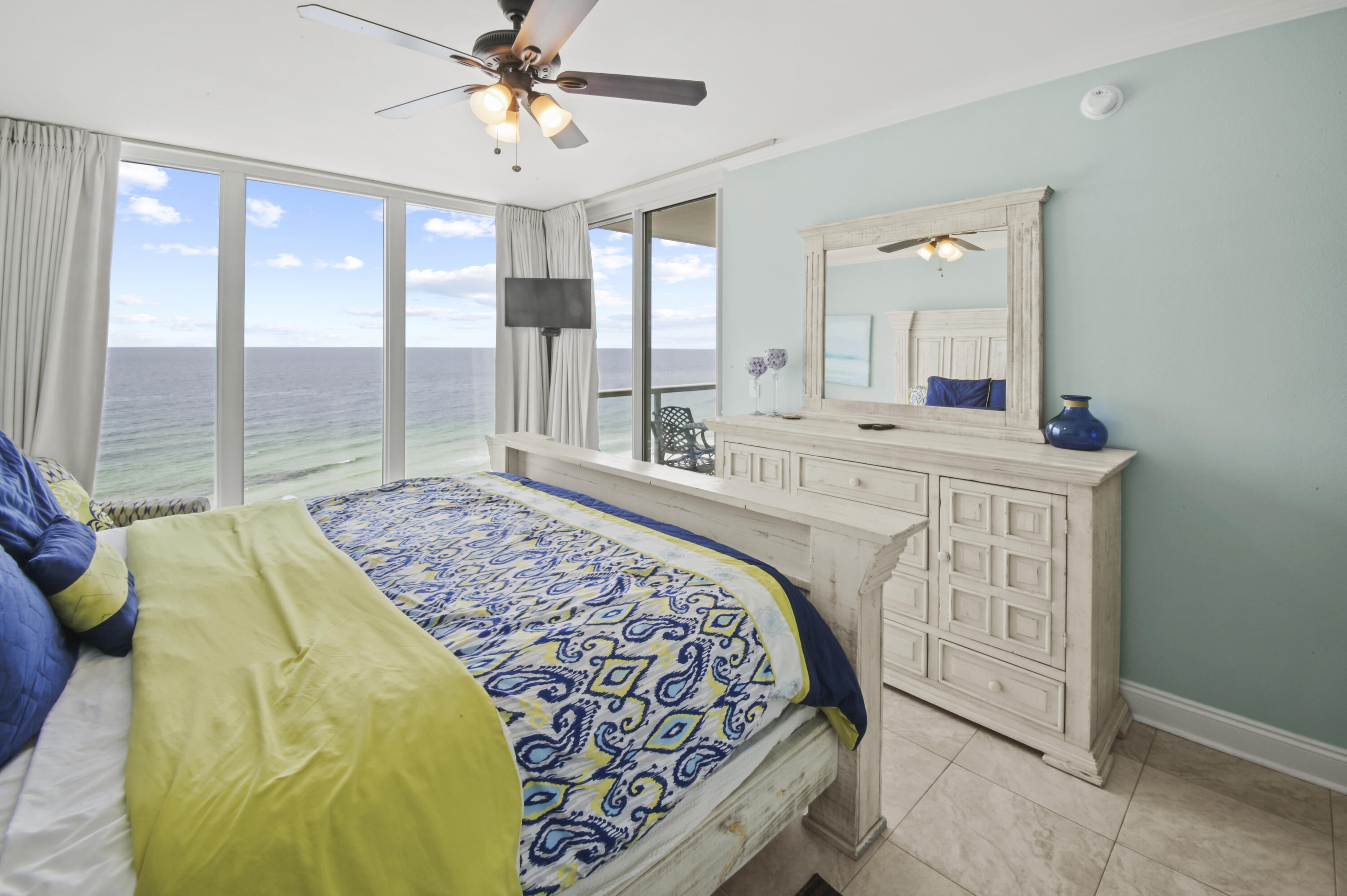 8477 Gulf Boulevard, Unit 902 Navarre, FL 32566 - Photo 13 of 36 a spacious bedroom with a bed and a chandelier
