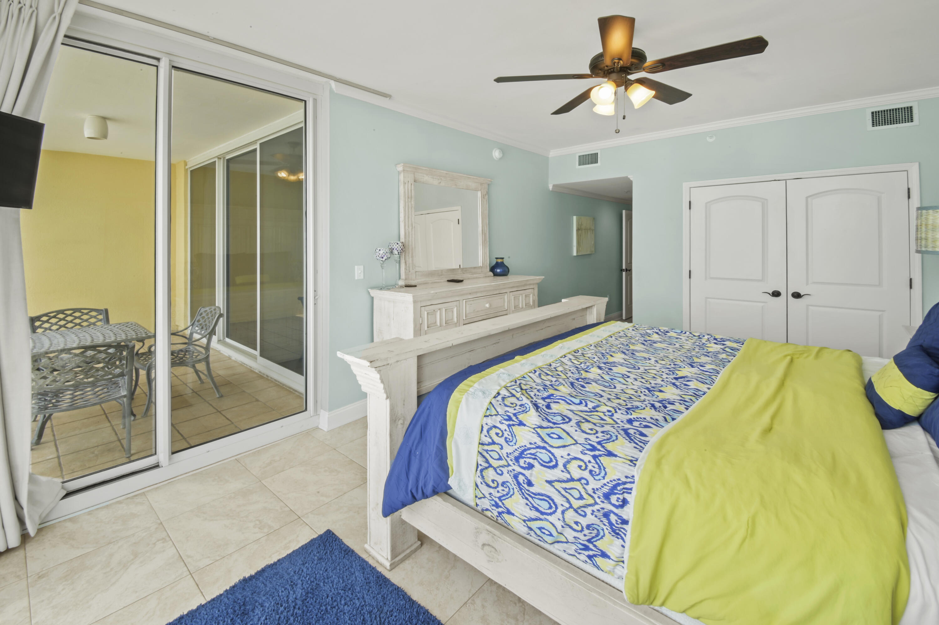 8477 Gulf Boulevard, Unit 902 Navarre, FL 32566 - Photo 14 of 36 a spacious bedroom with a bed and glass door
