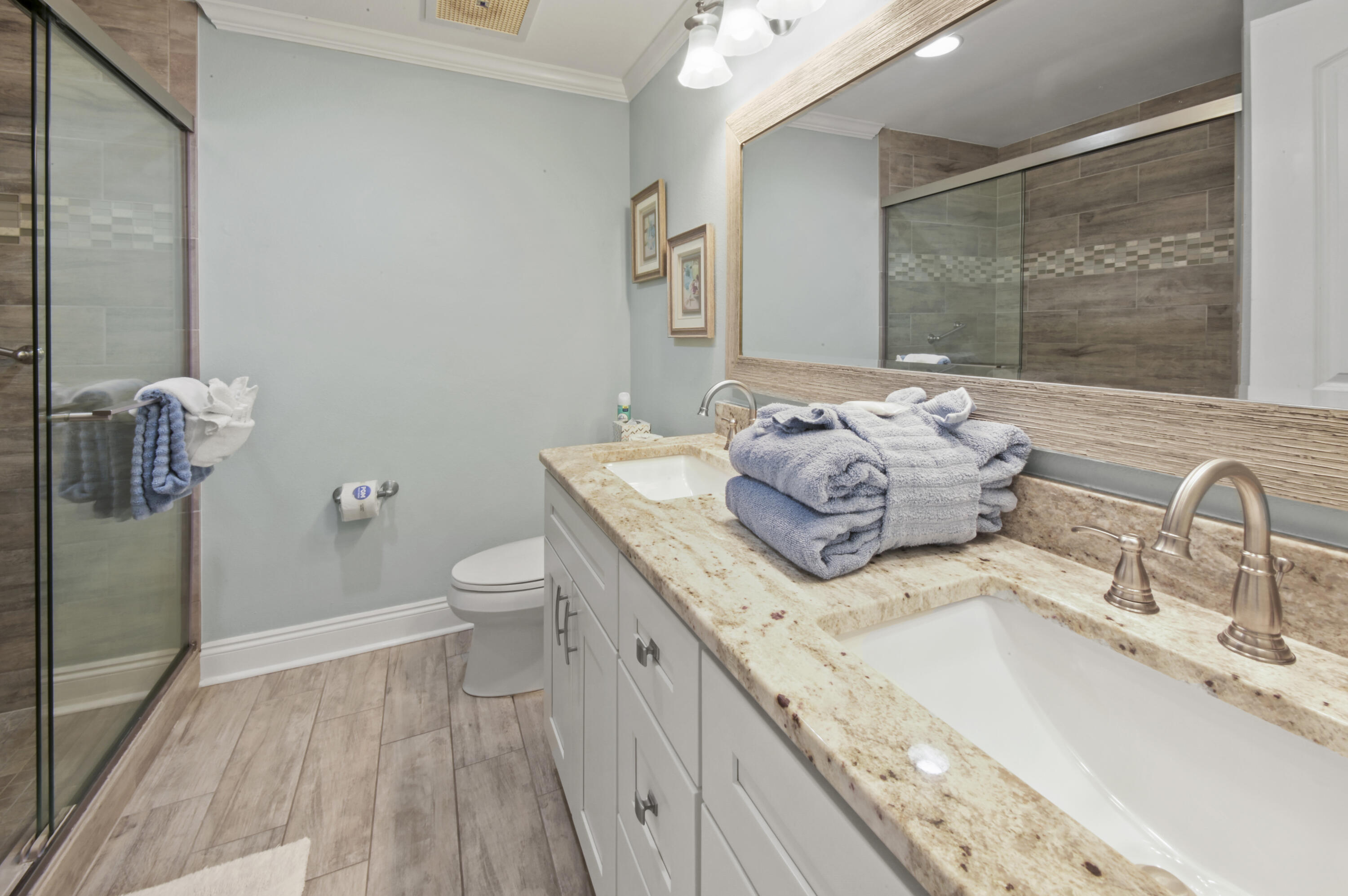 8477 Gulf Boulevard, Unit 902 Navarre, FL 32566 - Photo 16 of 36 a spacious bathroom with a granite countertop sink a toilet and a mirror