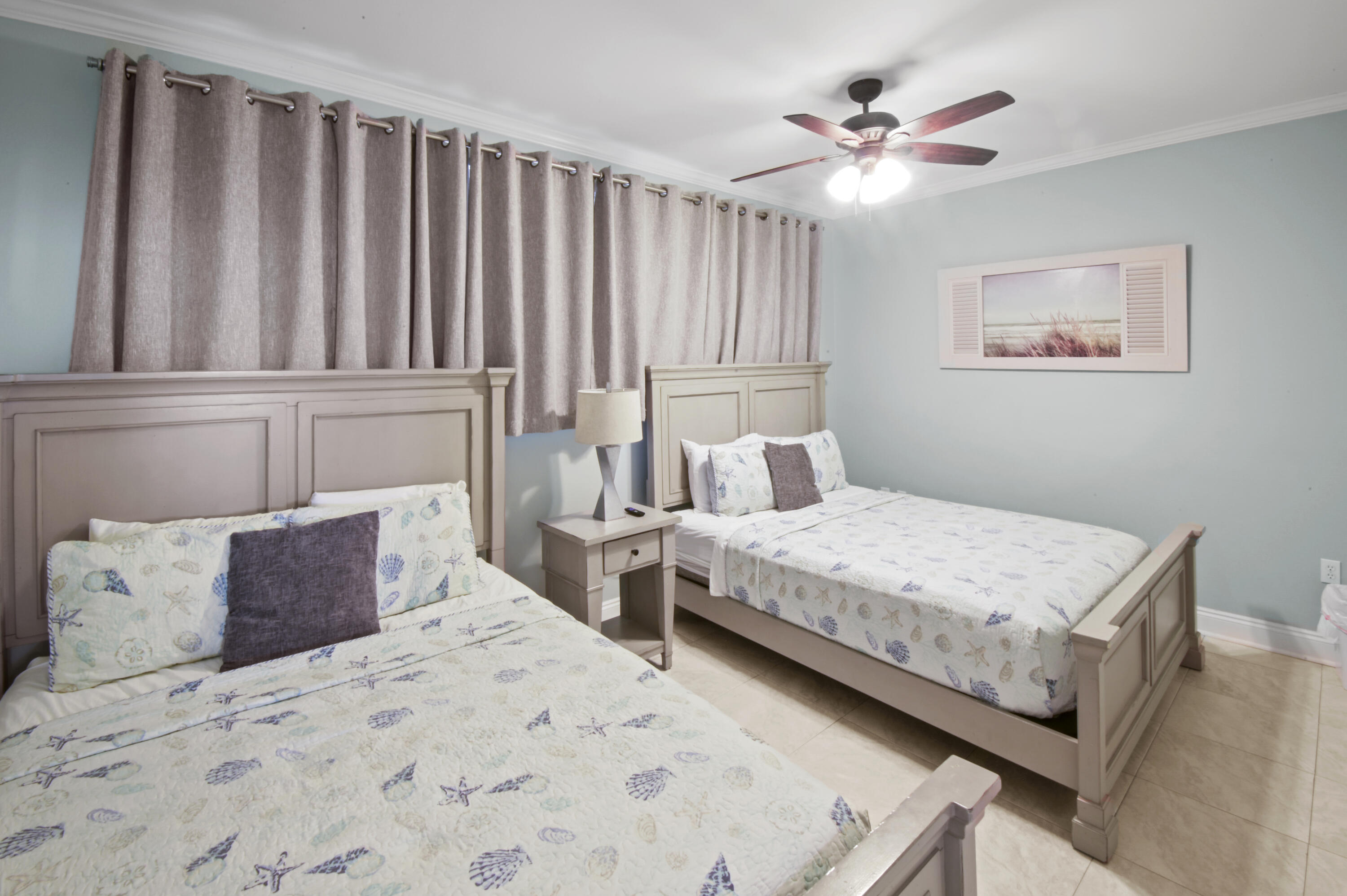 8477 Gulf Boulevard, Unit 902 Navarre, FL 32566 - Photo 17 of 36 a bedroom with a bed and a chandelier