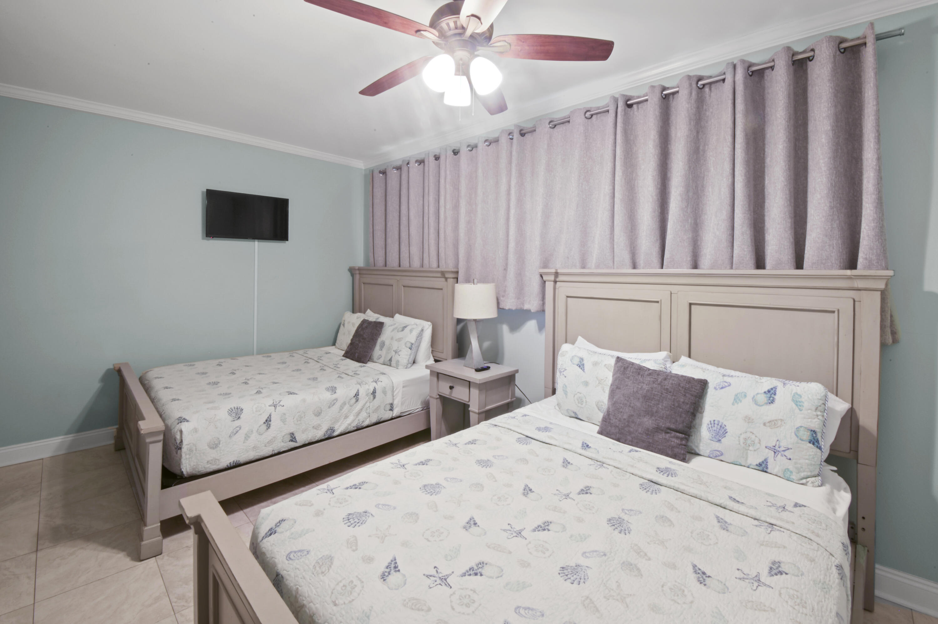 8477 Gulf Boulevard, Unit 902 Navarre, FL 32566 - Photo 18 of 36 a bedroom with two beds and a chandelier