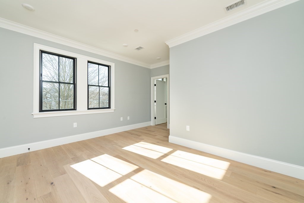120 Brookside Avenue, Unit 203 Boston, MA 02130 - Photo 14 of 18 an empty room with windows