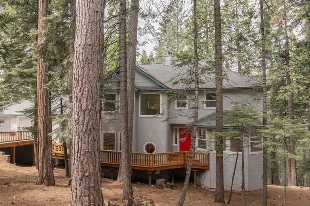 a living room with furniture fireplace and a large window