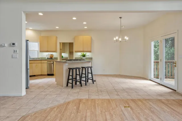 a kitchen with granite countertop a refrigerator and a stove