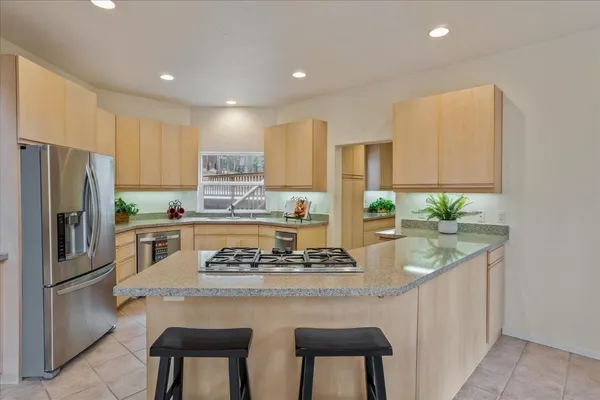 a kitchen with granite countertop white cabinets and white appliances