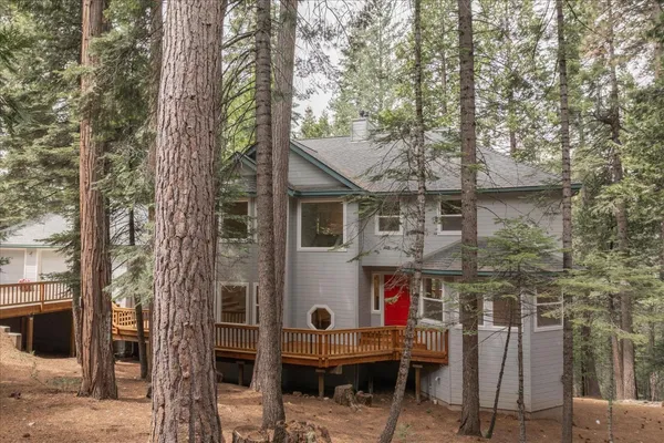 a living room with furniture fireplace and a large window