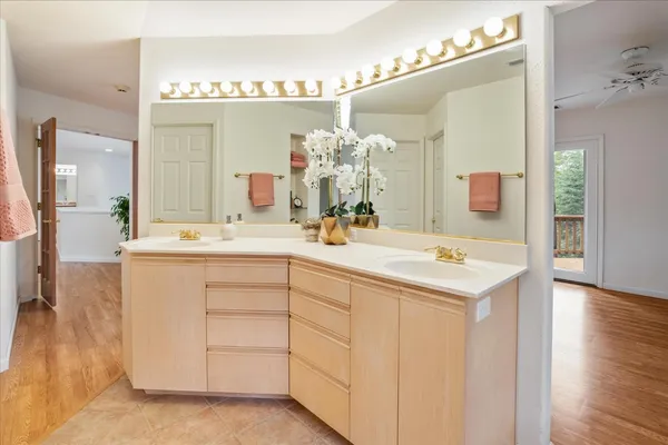 a kitchen with stainless steel appliances kitchen island granite countertop a table chairs and wooden floor