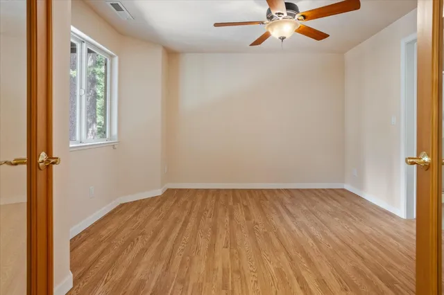 wooden floor in an empty room with a window