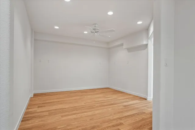 a view of a kitchen with wooden floor and stairs