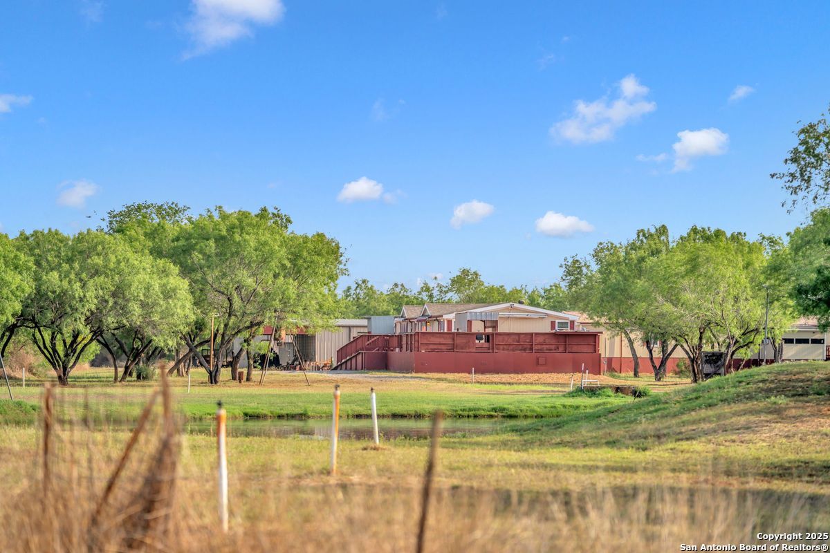 2654 Mathews Rnch Road Dilley, TX 78017 - Photo 15 of 39 a view of a swimming pool with a yard and plants