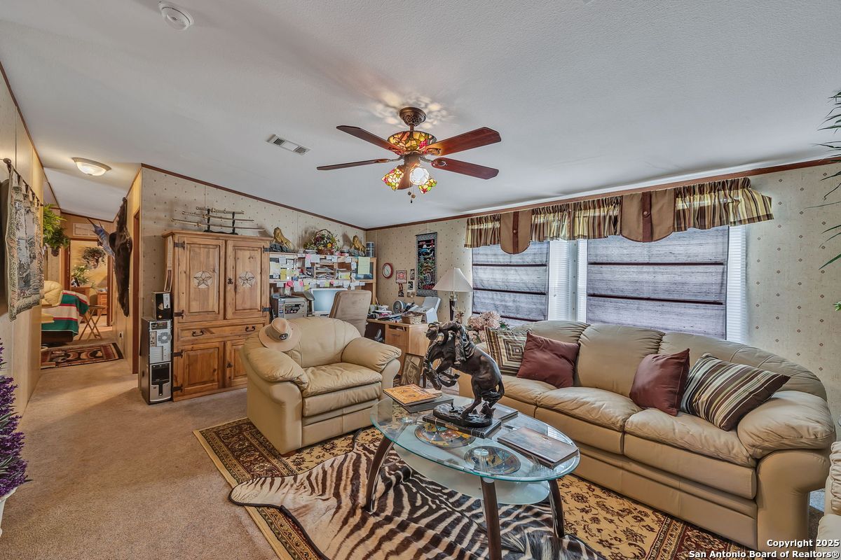 2654 Mathews Rnch Road Dilley, TX 78017 - Photo 27 of 39 a living room with furniture ceiling fan and a rug