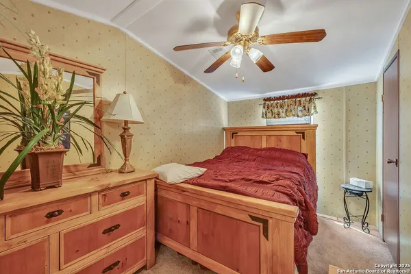 a bedroom with a bed and a potted plant