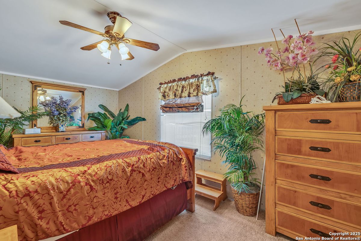 2654 Mathews Rnch Road Dilley, TX 78017 - Photo 32 of 39 a bedroom with a bed and a potted plant