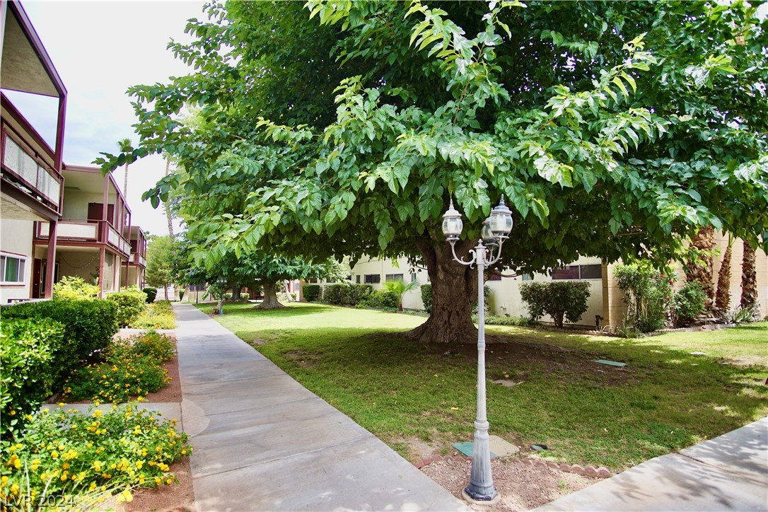 350 East Desert Inn Road, Unit F104 Las Vegas, NV 89109 - Photo 54 of 98 Looking east up the path toward Bldg F. Mature landscaping.