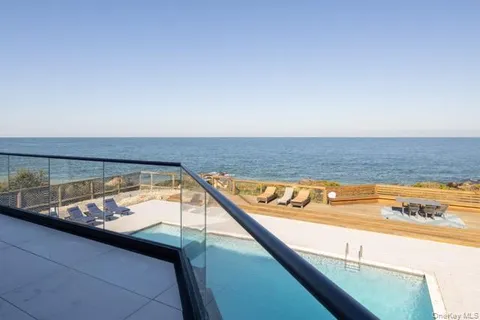 a view of swimming pool with outdoor seating
