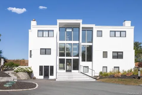 a front view of a building with a yard