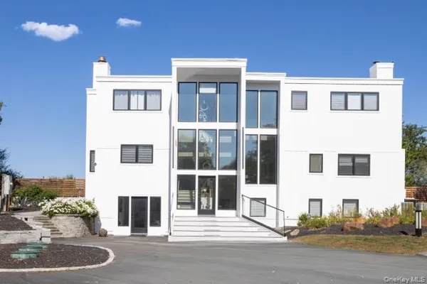 a front view of a building with a yard