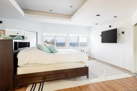 a spacious bedroom with a bed and a flat screen tv