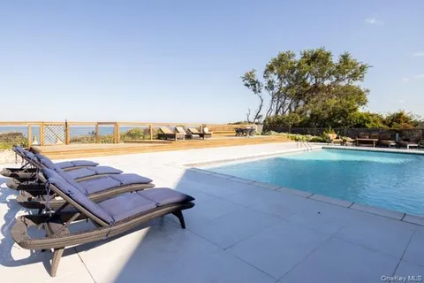 a living room with furniture a rug and a flat screen tv