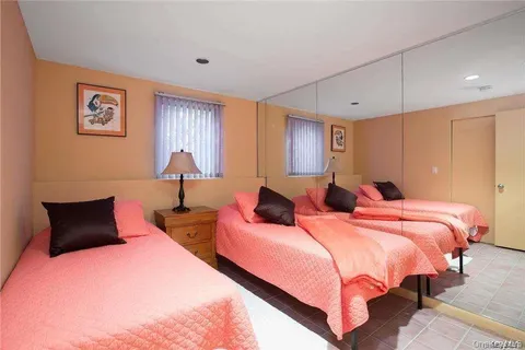 a bedroom with a bed and a night stand