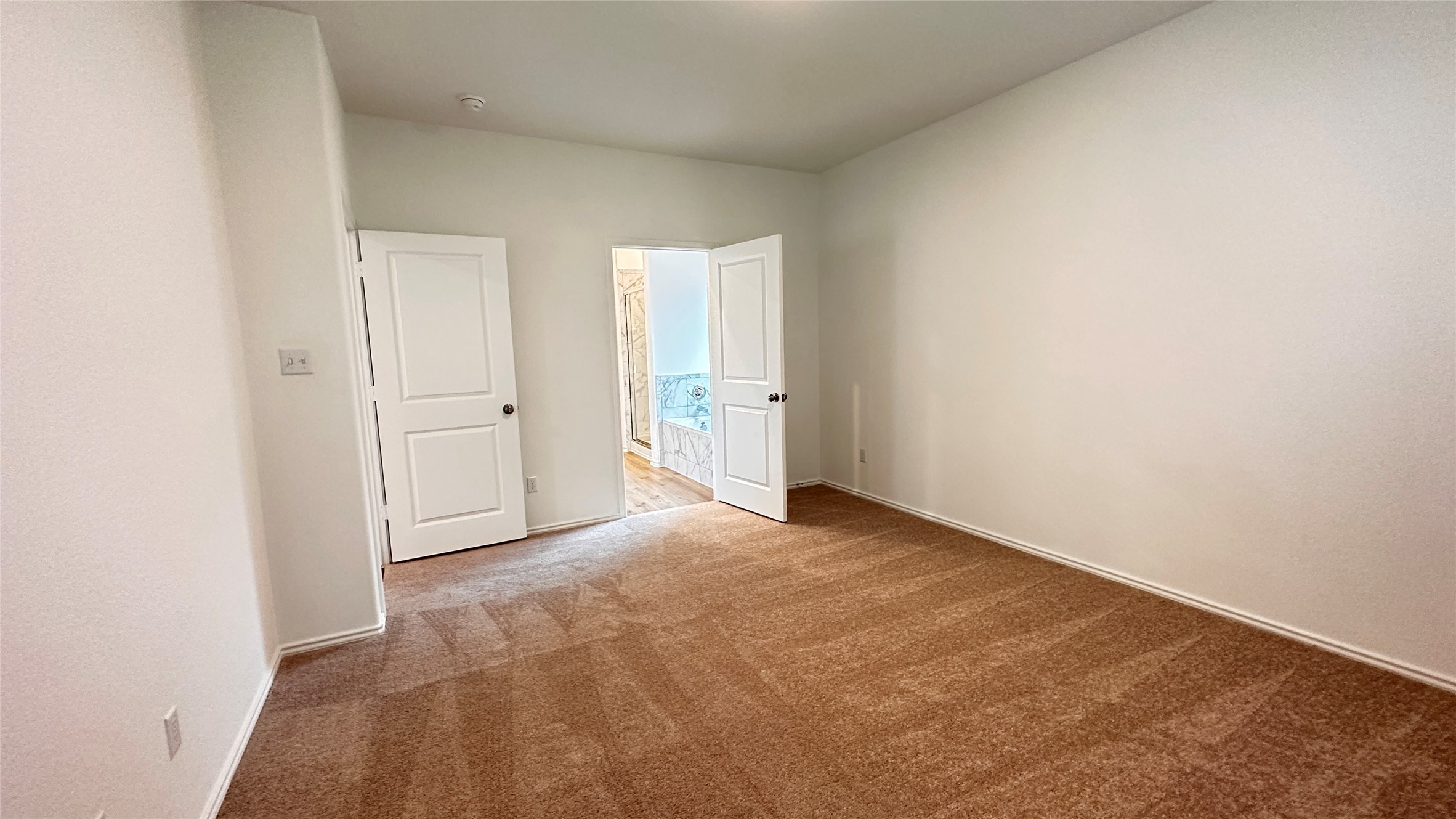 138 Milliner Loop Hutto, TX 78634 - Photo 14 of 36 Empty room with light carpet and baseboards