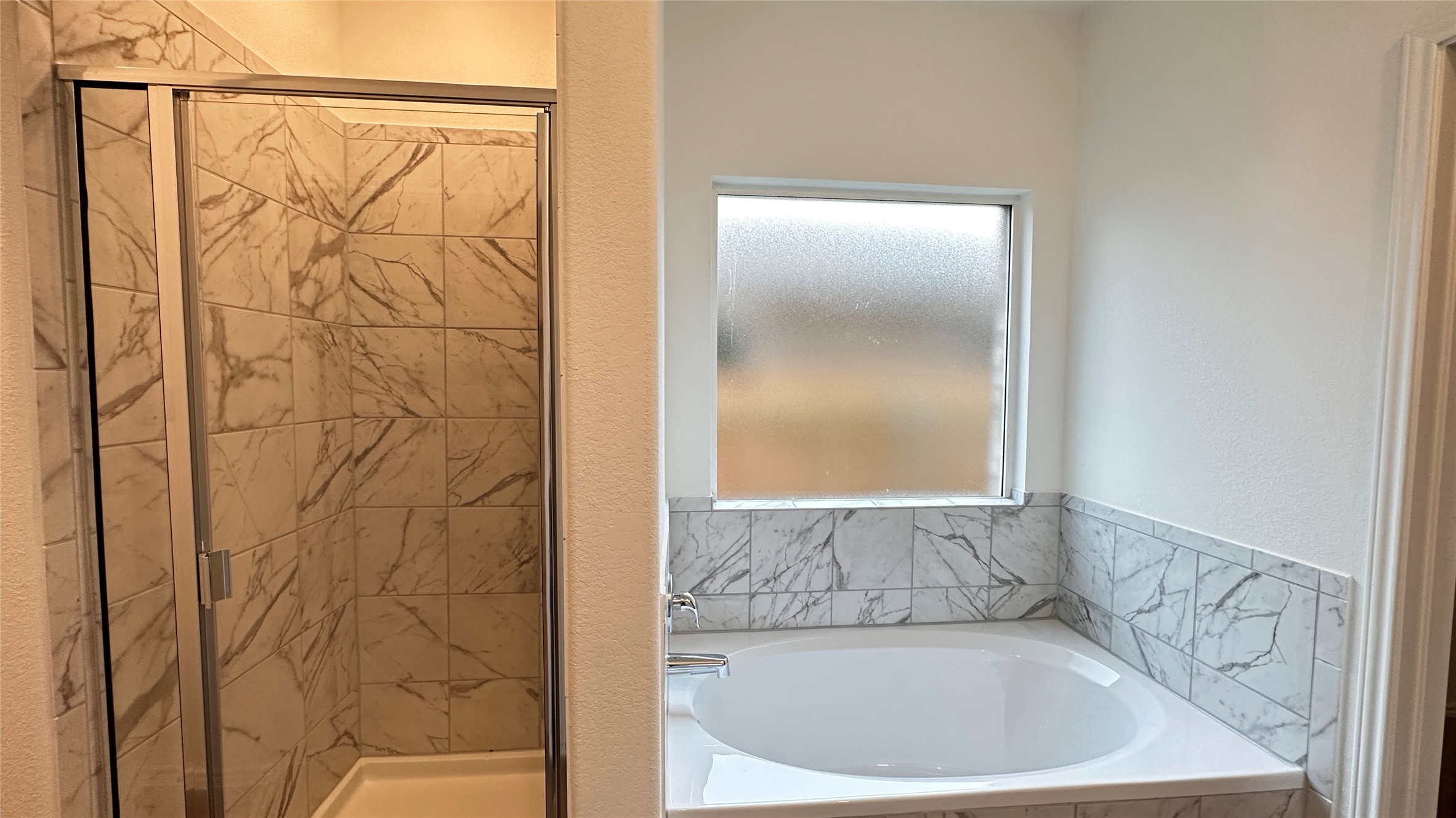 138 Milliner Loop Hutto, TX 78634 - Photo 15 of 36 Full bathroom featuring a shower stall and healthy amount of natural light