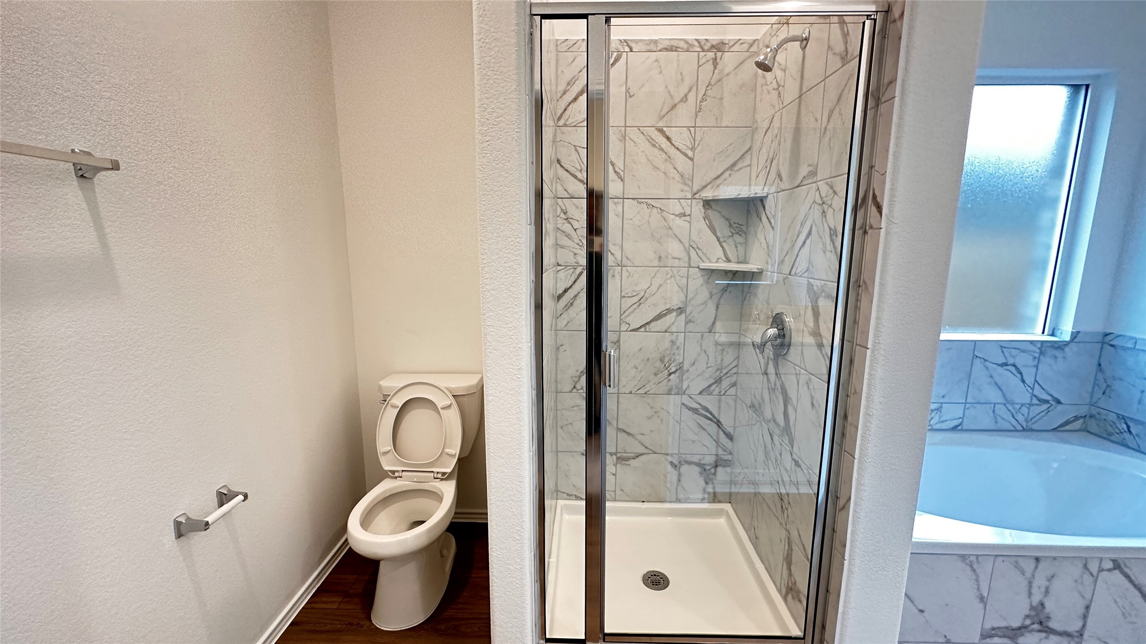 138 Milliner Loop Hutto, TX 78634 - Photo 17 of 36 Bathroom featuring a marble finish shower, a garden tub, and a textured wall