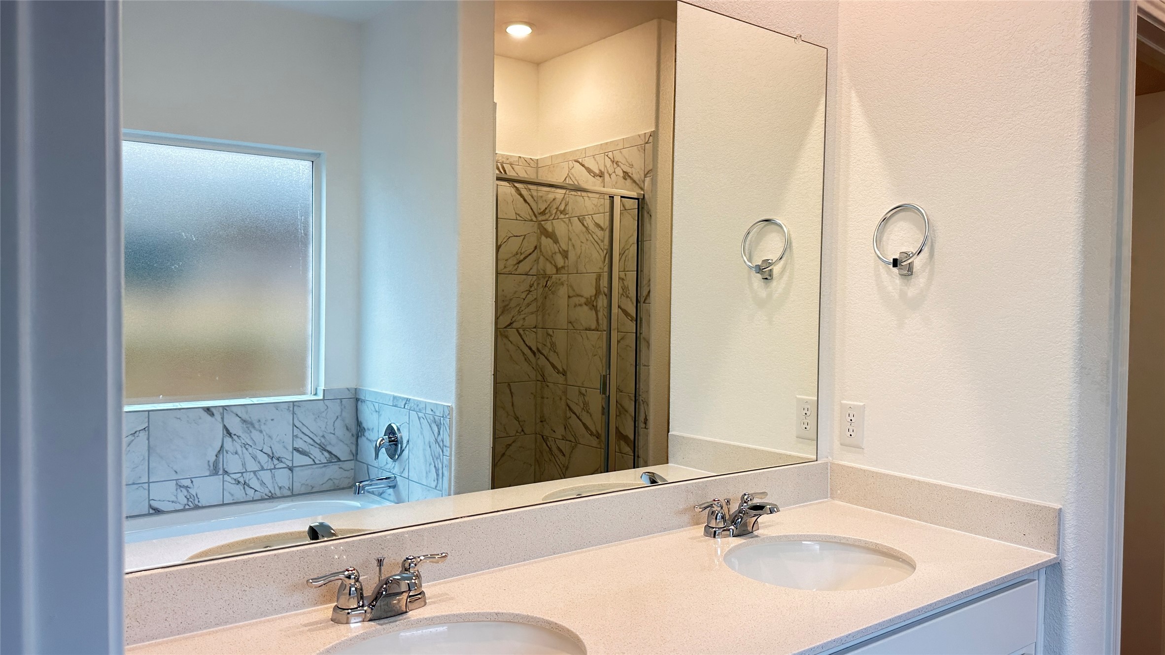 138 Milliner Loop Hutto, TX 78634 - Photo 18 of 36 Bathroom with double vanity, a bath, and a shower stall