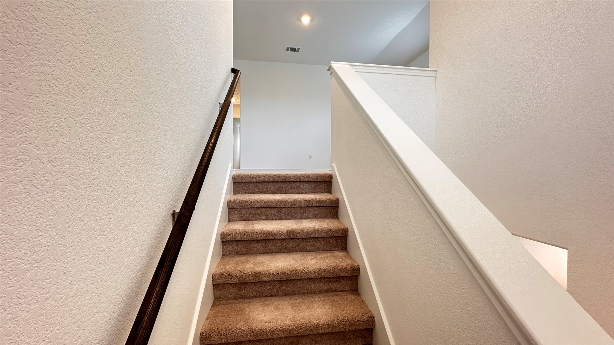 138 Milliner Loop Hutto, TX 78634 - Photo 21 of 36 Staircase featuring a textured wall and recessed lighting