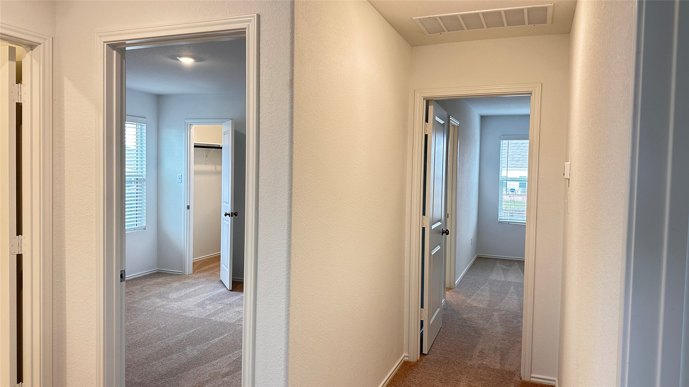 138 Milliner Loop Hutto, TX 78634 - Photo 24 of 36 Corridor featuring light colored carpet and baseboards
