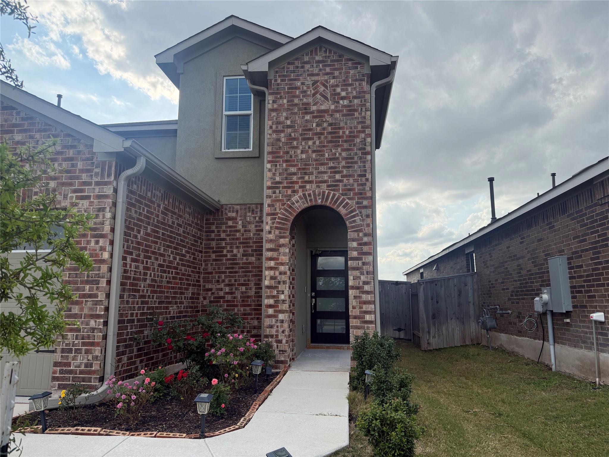 138 Milliner Loop Hutto, TX 78634 - Photo 3 of 36 Entrance to property featuring brick siding and stucco siding